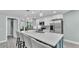 A well-lit kitchen featuring a spacious island, stainless steel appliances, and an open floor plan at 1901 Paddock Dr, Plant City, FL 33566