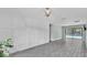 Bright living room featuring updated plank floors, updated light fixture, and sliding door access to the pool area at 1901 Paddock Dr, Plant City, FL 33566
