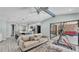 Open living space featuring a kitchen island, a cozy couch, and a view of the pool at 1901 Paddock Dr, Plant City, FL 33566