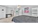 Spacious bedroom with art, a mirror, and access to another room at 1901 Paddock Dr, Plant City, FL 33566
