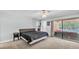 Spacious bedroom with sliding glass doors, neutral paint, and access to the pool area at 1901 Paddock Dr, Plant City, FL 33566