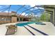 Beautiful view of the screened pool and spa surrounded by a lush green landscape at 1901 Paddock Dr, Plant City, FL 33566