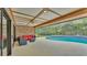 Screened-in lanai featuring a private pool, poolside furniture, and brick accents at 1901 Paddock Dr, Plant City, FL 33566