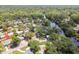 Aerial view of the property with lush trees, a river and surrounding homes at 1905 E Broad St, Tampa, FL 33610