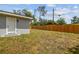 Outdoor view featuring a wooden fence and a gray exterior, offering privacy and charm at 1905 E Broad St, Tampa, FL 33610