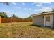 Spacious backyard features a wooden fence, providing privacy and security to the property at 1905 E Broad St, Tampa, FL 33610