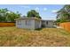This backyard showcases a gray exterior, offering a serene retreat with ample lawn space at 1905 E Broad St, Tampa, FL 33610