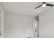 Bedroom with a ceiling fan, white closet doors and a white interior door at 1905 E Broad St, Tampa, FL 33610