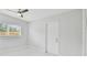 Bright bedroom with window, ceiling fan, and a white door at 1905 E Broad St, Tampa, FL 33610