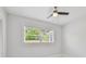 Light filled bedroom with ceiling fan and window at 1905 E Broad St, Tampa, FL 33610