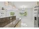Open dining area with stylish chandelier lighting, granite counter and lots of natural light from large windows at 1905 E Broad St, Tampa, FL 33610