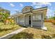 Charming home with a well-maintained front yard and ample sunlight at 1905 E Broad St, Tampa, FL 33610