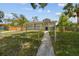 Inviting front exterior view of a gray home with a well-maintained lawn and secure fencing at 1905 E Broad St, Tampa, FL 33610