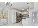 Kitchen view with stainless steel appliances, granite counters, white cabinetry, and breakfast bar at 1905 E Broad St, Tampa, FL 33610