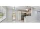 Modern kitchen with stainless steel appliances, granite countertops, and white cabinetry that are brightly lit at 1905 E Broad St, Tampa, FL 33610