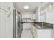 Bright modern kitchen features granite countertops, and stainless-steel appliances and white marbled floors at 1905 E Broad St, Tampa, FL 33610