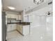 Bright open floor plan with sleek tile flooring and granite countertops at breakfast bar into kitchen area at 1905 E Broad St, Tampa, FL 33610