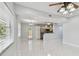 Open concept living and dining area with white marbled floors and access to the modern kitchen and backyard at 1905 E Broad St, Tampa, FL 33610