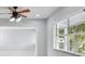 View of living room with ceiling fan and window with blinds at 1905 E Broad St, Tampa, FL 33610
