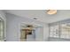 Open-concept living space with a view of the kitchen, neutral colors, and lots of natural light at 1905 E Broad St, Tampa, FL 33610