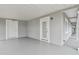 Covered patio with gray floor and exterior doors and windows at 1905 E Broad St, Tampa, FL 33610