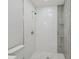 Shower with white tiles and gray accent and glass shelves at 1905 E Broad St, Tampa, FL 33610