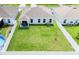 Aerial view of backyard with white fence, covered patio area and well maintained grassy area at 191 Brofield St, Brooksville, FL 34604