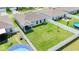 Aerial view of a spacious backyard with a white fence, pool, and plenty of green space for outdoor activities at 191 Brofield St, Brooksville, FL 34604