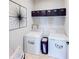 Efficient laundry room featuring modern washer and dryer with storage bins on the wall at 191 Brofield St, Brooksville, FL 34604