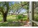 Serene backyard with mature trees and lush landscaping offers a private retreat at 2003 Greenbriar Blvd # 8, Clearwater, FL 33763