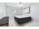 Cozy bedroom featuring neutral walls, modern ceiling fan, and bright window at 2003 Greenbriar Blvd # 8, Clearwater, FL 33763