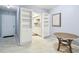 Bright dining area showcasing built-in shelving and a glimpse into the adjacent modern kitchen at 2003 Greenbriar Blvd # 8, Clearwater, FL 33763