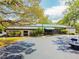 The community clubhouse has ample parking and beautiful trees at 2003 Greenbriar Blvd # 8, Clearwater, FL 33763