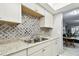 Bright kitchen showcasing stainless steel sink, granite countertops, and decorative tile backsplash at 2003 Greenbriar Blvd # 8, Clearwater, FL 33763