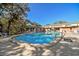 Inviting community pool area with lounge chairs, umbrellas, and crystal-clear water at 2003 Greenbriar Blvd # 8, Clearwater, FL 33763