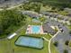 This aerial view showcases community amenities including a pool, tennis and basketball courts, a clubhouse and residences at 20108 Stone Pine Cir, Lutz, FL 33558