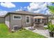Well-maintained backyard features a hot tub, paver patio, and lush green lawn at 20108 Stone Pine Cir, Lutz, FL 33558