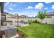 Backyard featuring a hot tub, paver patio, lush lawn, and well-maintained landscaping at 20108 Stone Pine Cir, Lutz, FL 33558