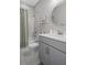 Bathroom featuring a shower and tub with white marble tile surround and gray vanity at 20108 Stone Pine Cir, Lutz, FL 33558