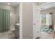 Modern bathroom featuring a shower and tub with white marble tile surround and gray vanity at 20108 Stone Pine Cir, Lutz, FL 33558