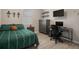 Bedroom featuring a striped green bedspread, gray dresser, a desk and wall shelves at 20108 Stone Pine Cir, Lutz, FL 33558