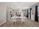 Bright dining area with modern light fixture, open to kitchen with stainless steel appliances at 20108 Stone Pine Cir, Lutz, FL 33558