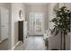Welcoming entryway featuring wood-look floors, decorative accents, and a stylish console table at 20108 Stone Pine Cir, Lutz, FL 33558