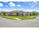Corner lot home with lush green lawns, mature trees, and a three-car garage at 20108 Stone Pine Cir, Lutz, FL 33558