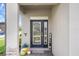 Welcoming front door with decorative glass, colorful planters, and a charming welcome sign at 20108 Stone Pine Cir, Lutz, FL 33558