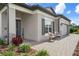 Charming front entrance with a welcome sign, stone accents, and a cozy seating area at 20108 Stone Pine Cir, Lutz, FL 33558