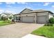 The home features a large three-car garage and brick paver driveway at 20108 Stone Pine Cir, Lutz, FL 33558