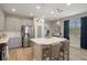 Open kitchen with large center island, gray cabinets, stainless steel appliances, and pendant lighting at 20108 Stone Pine Cir, Lutz, FL 33558