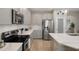 Kitchen with an island, gray cabinets, stainless steel appliances, and subway tile backsplash at 20108 Stone Pine Cir, Lutz, FL 33558