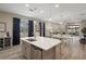Kitchen with large center island, gray cabinets, stainless steel appliances, and adjacent living area at 20108 Stone Pine Cir, Lutz, FL 33558
